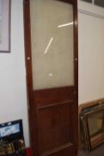 A glass panelled door, 72cm wide by 222cm high
