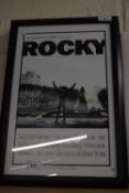 A set of 4 framed and glazed reproduction film posters, to include: - Breakfast at Tiffany's - Rocky