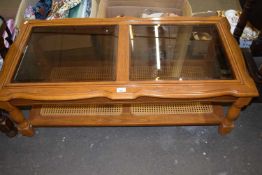 Glass topped coffee table with rattan under tier, approx 118cm wide