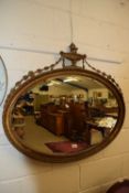 OVAL WALL MIRROR SET IN A GILT FINISH FRAME, WITH URN MOUNT, 98CM WIDE