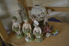 THREE FIGURES OF CHERUBS HOLDING BASKETS OF FLOWERS TOGETHER WITH ANOTHER FIGURE SIMILAR, AND A