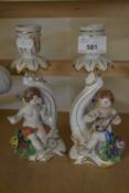 PAIR OF CONTINENTAL FLORAL DECORATED CANDLESTICKS WITH CHERUBS