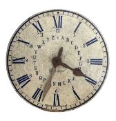 A vintage educational clock face formed from plywood with Roman numerals and letters of the