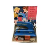 A boxed child's Vulcan sewing machine in blue.
