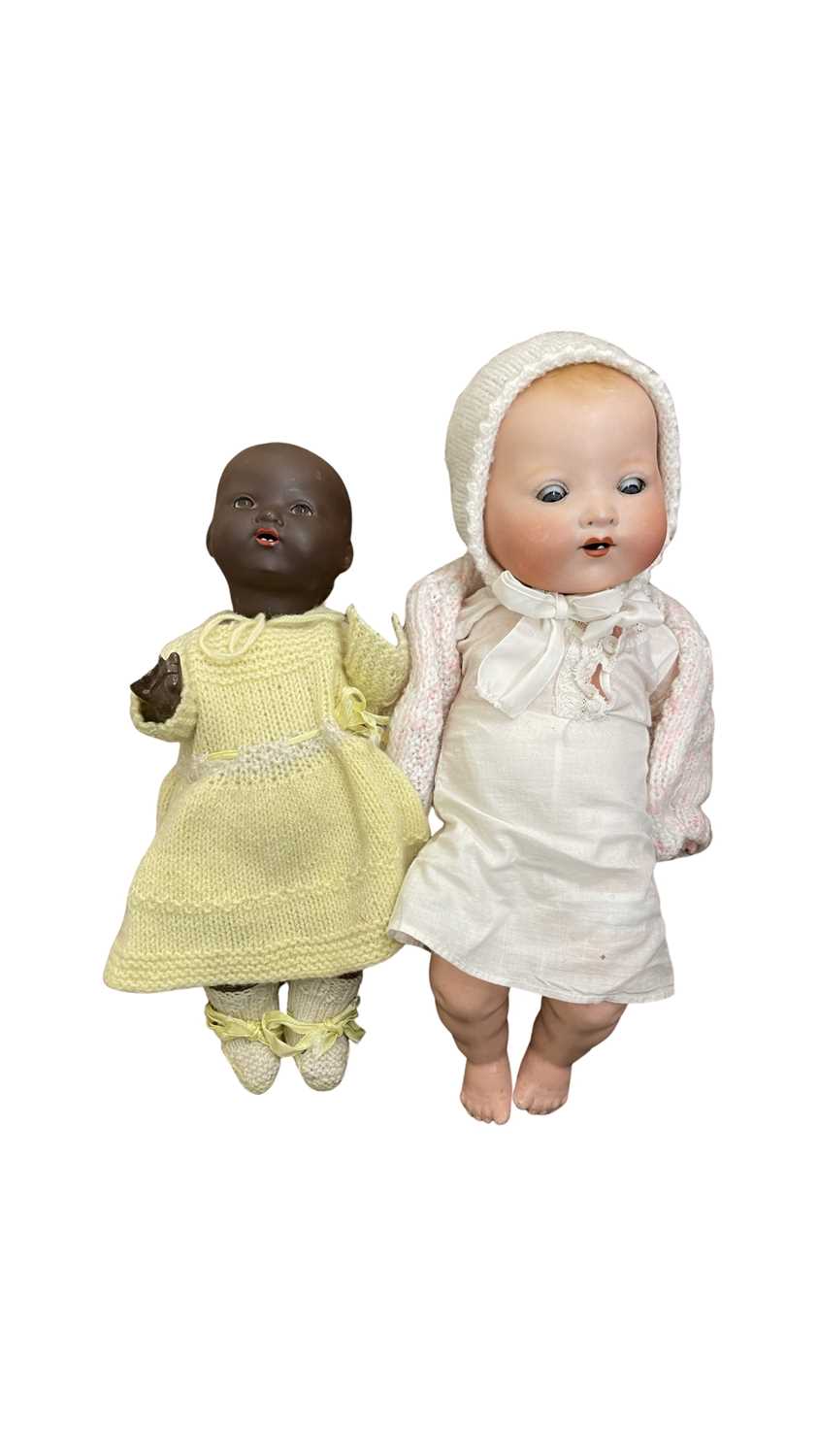 A pair of European bisque head dolls, to include: - AM Germany 351/3 1/2K, wearing linen dress and