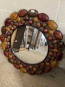 Modern circular wall mirror set in a metal pebble effect frame