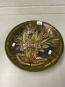 Russian pottery charger decorated with a raised design of flowers