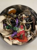 Tin of various assorted costume jewellery