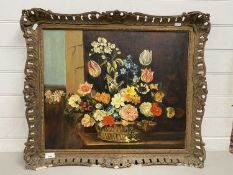 20th Century school still life study of a basket of flowers set in a swept pierced gilt frame, oil