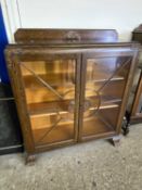 Early 20th Century oak two door china display cabinet with floral carved decoration