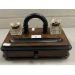 Late 19th Century walnut and ebonised desk stand with clear glass ink wells