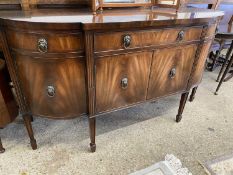 Reproduction mahogany bow front sideboard with three drawers and four doors raised on tapering