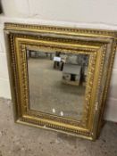 19th Century gilt picture frame containing a bevelled mirror