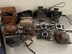 Box of various assorted film cameras to include Praktica, Chinon and various others