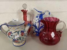 Mixed Lot: Cranberry glass jugs and two further floral decorated jugs (4)