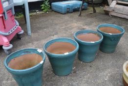 Set of four turquoise glazed flower pots