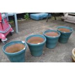 Set of four turquoise glazed flower pots