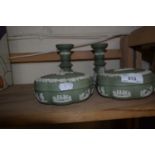 Pair of green Wedgwood Jasper ware candlesticks together with a pair of matching trinket pots