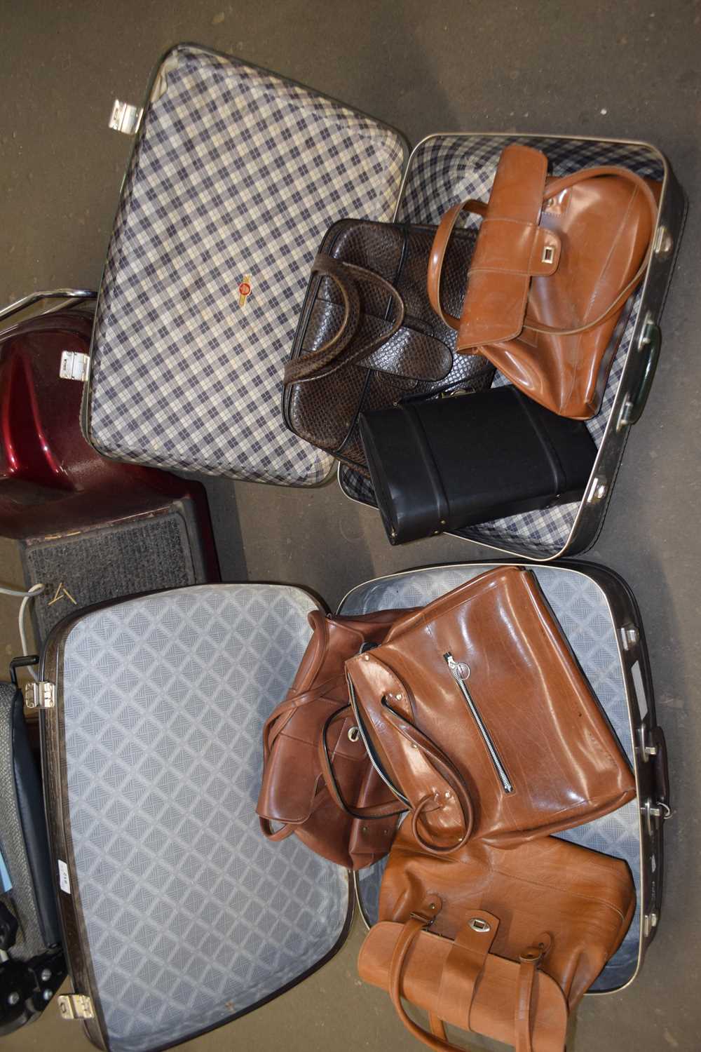 Two suitcases and assorted handbags