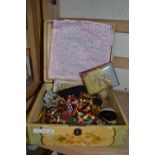 Floral decorated box containing a small quantity of costume jewellery