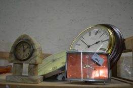 Two wall clocks, a mantel clock and a stone ware mantel clock