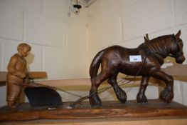 Carved wooden model of a shire horse ploughing