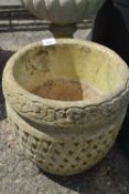 Circular concrete planter with meshed decoration