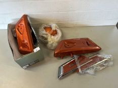 Orange painted motorcycle parts for a Yamaha R5 motorcycle, contains battery cover, oil tank, badges