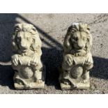 Pair of composite statues formed as lions holding a crest, height 40cm