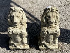 Pair of composite statues formed as lions holding a crest, height 40cm