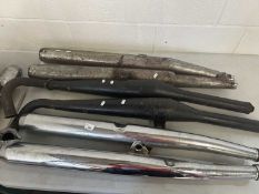 Quantity of used motorcycle mufflers of various shapes and sizes