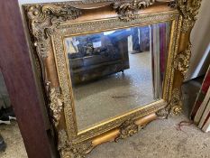 Reproduction bevelled rectangular wall mirror set in a heavy gilt effect frame, 64cm wide