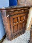 Georgian oak corner cabinet with panelled door and single drawer base