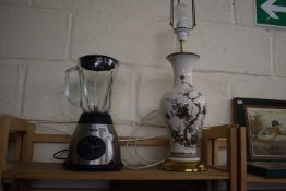 A Tower Juicer/Blender together with a ceramic lamp