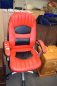 Red upholstered revolving office chair