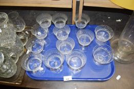 Quantity of assorted drinking glasses to include eleven engraved wine/champagne glasses and two
