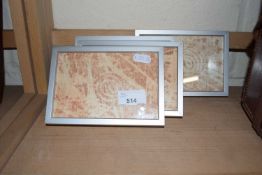 Four abstract prints in aluminium effect frames