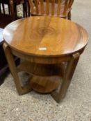 An Art Deco style walnut occasional table with circular top over two shelves, 58cm diameter