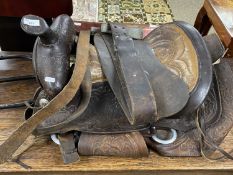 Leather saddle with stirrups and accompanying saddle stand