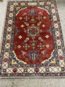 Modern wool floor rug with central red panel, 163 x 130cm