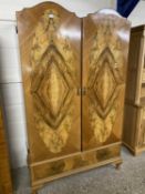 20th Century two door walnut veneered wardrobe with arched doors over a single drawer base, 118cm