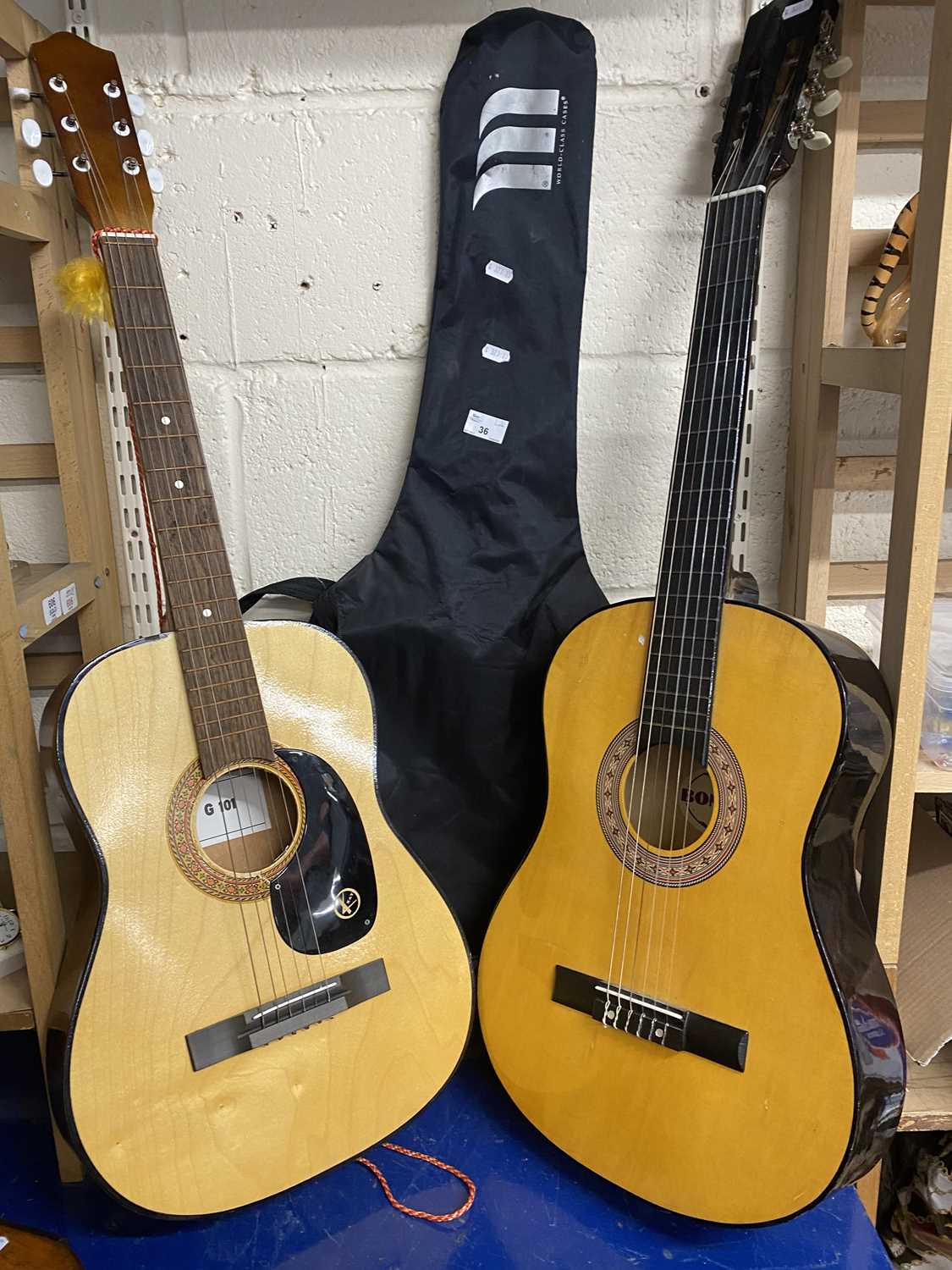 A Kay G101 acoustic guitar together with a Bon Play guitar