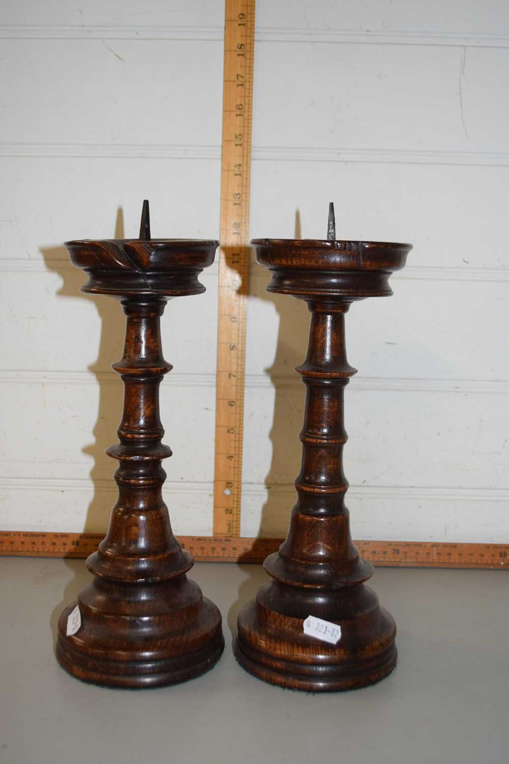 A pair of turned hardwood candlesticks