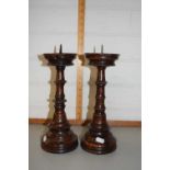 A pair of turned hardwood candlesticks