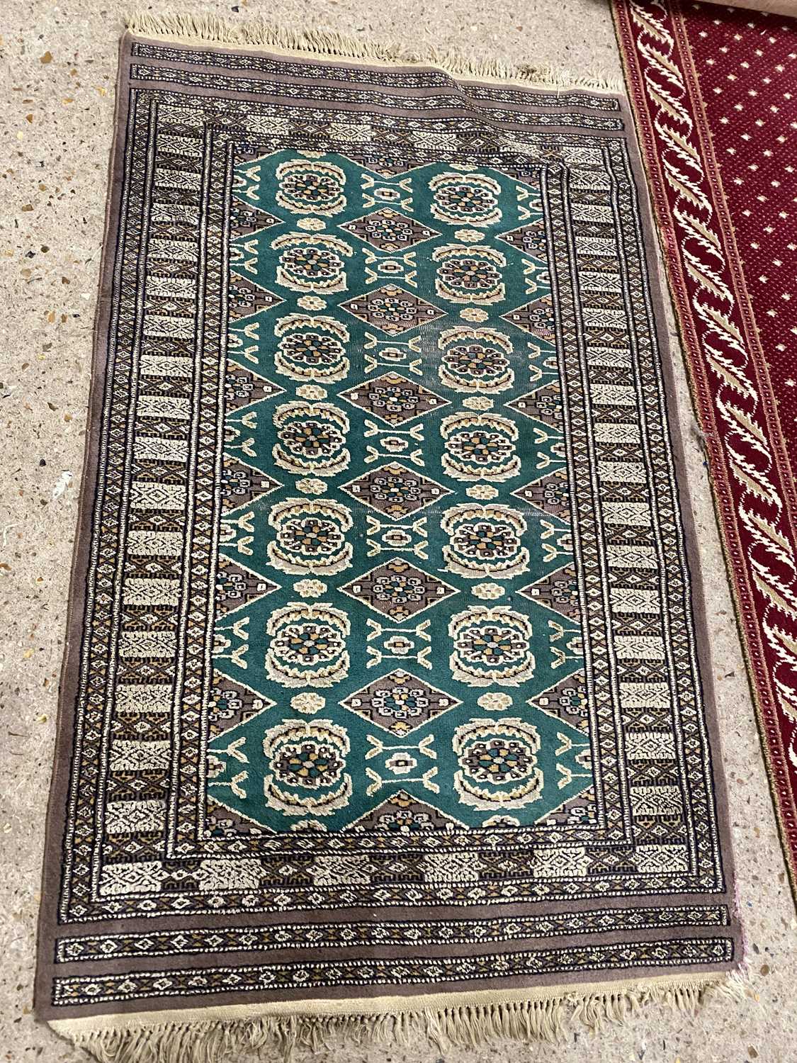 20th Century floor rug decorated with geometric design on a green background, 93 x 145cm