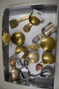 Group of brass and white metal caddy spoons with enamelled tops