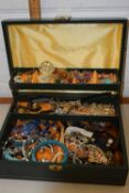 A jewel box containing a quantity of costume jewellery and watches to include bangles, faux