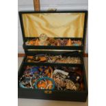 A jewel box containing a quantity of costume jewellery and watches to include bangles, faux