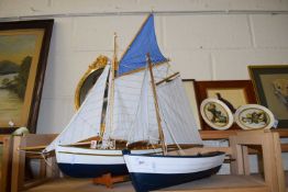 Two navy blue and white model pond yachts