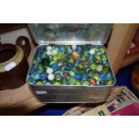 Sandwich tin full of assorted glass marbles